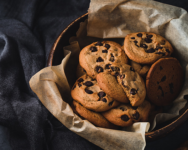 Illustration of a motorcycle helmet, laptop and privacy icons symbolizing online safety.